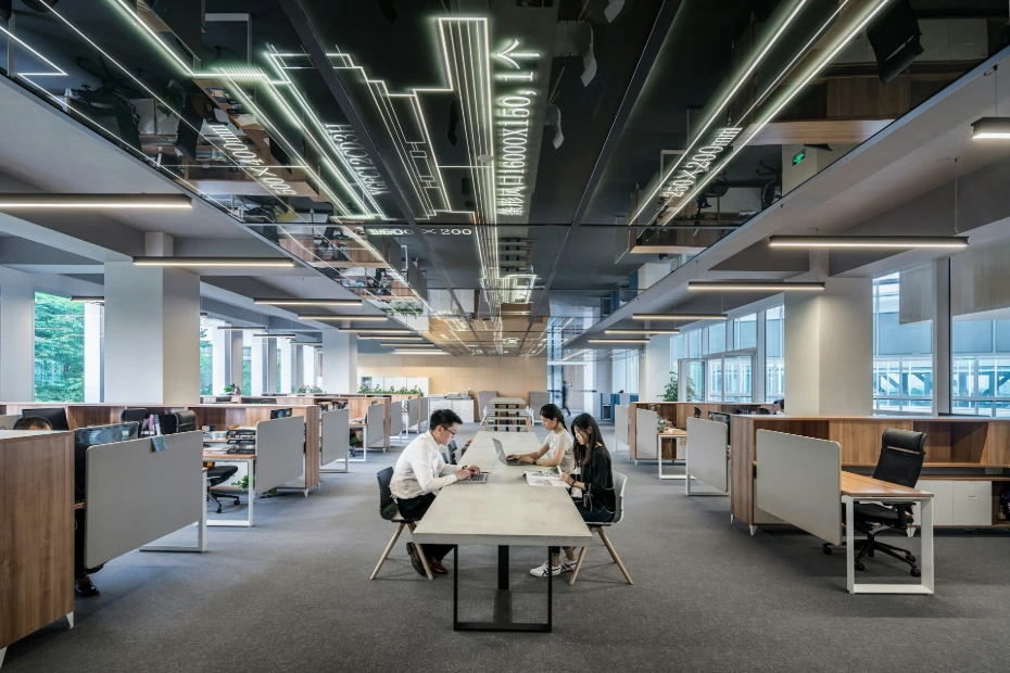 three people collaborating in open office